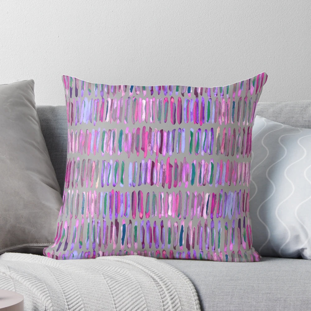 Messy watercolor stripes in pink and purple on a throw pillow