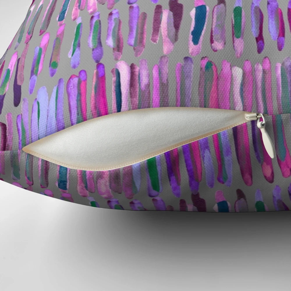 Messy watercolor stripes in pink and purple on a throw pillow