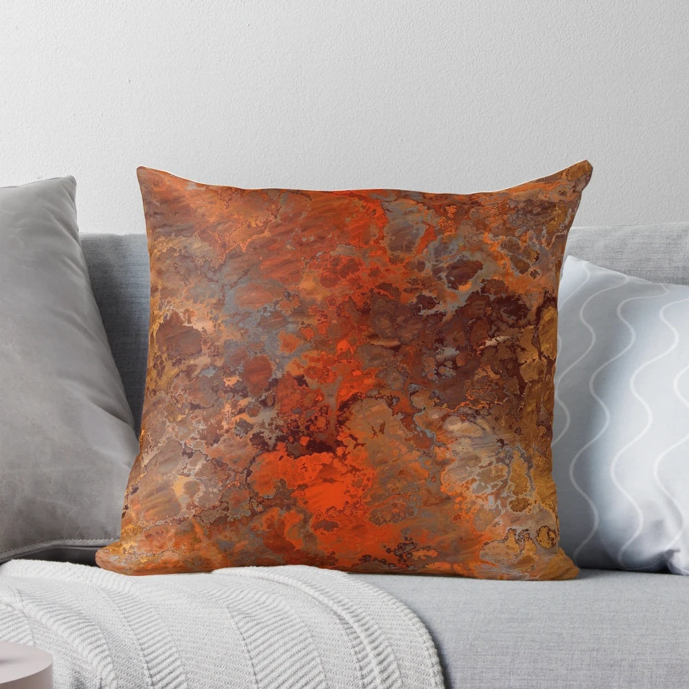 Decorative abstract throw pillow with metallic gold and rust accents