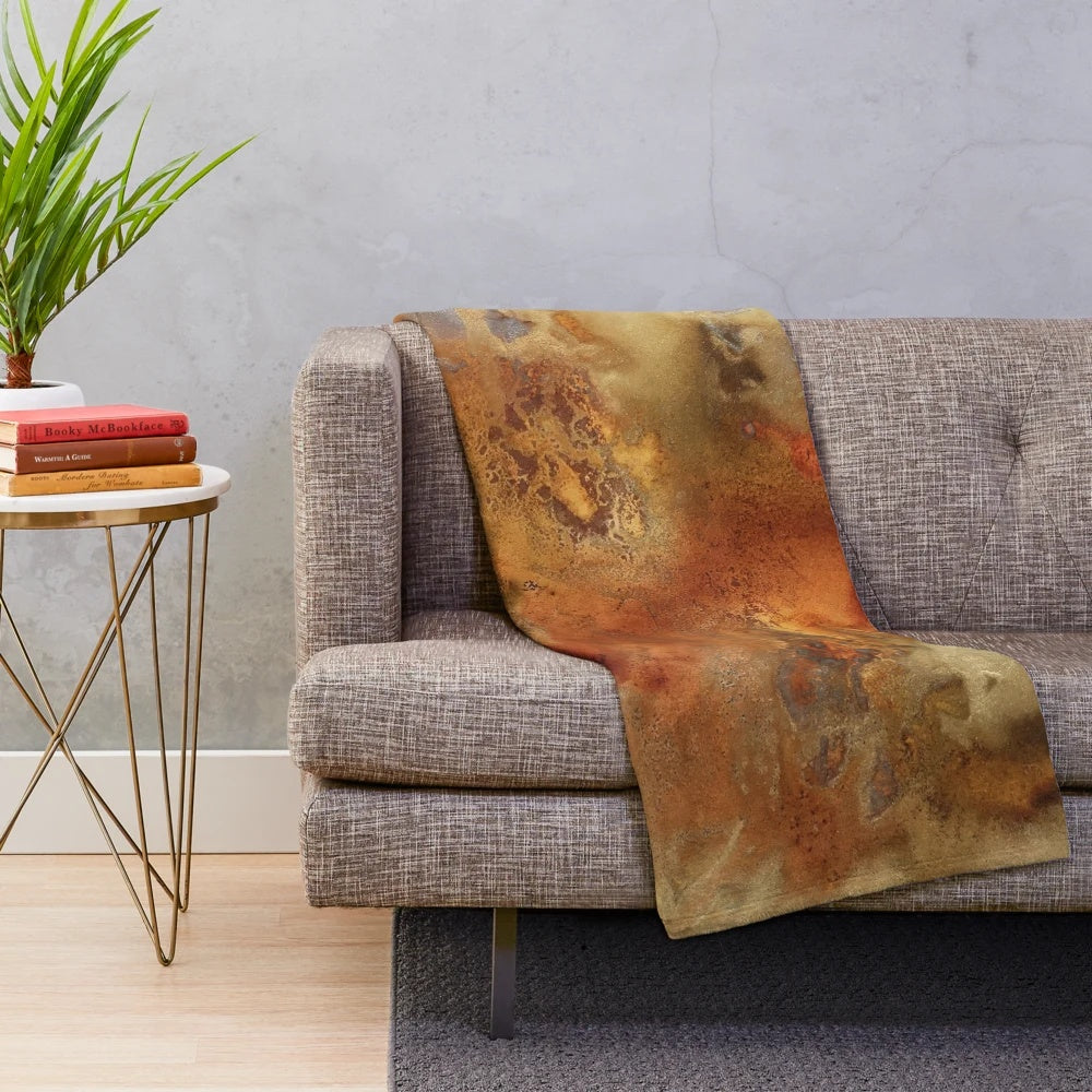 Metallic plush blanket with swirling abstract liquid art in gold, bronze, and copper tones