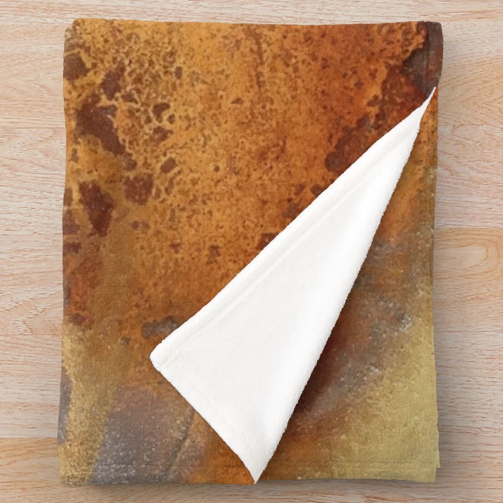 Metallic plush blanket with swirling abstract liquid art in gold, bronze, and copper tones