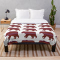 Metis-inspired plush blanket with bear and sash design, celebrating indigenous Canadian culture