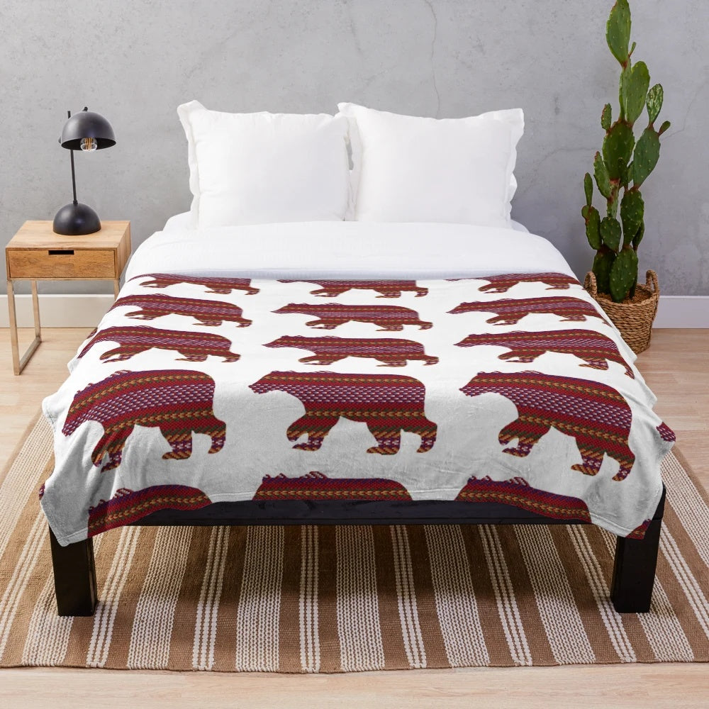 Metis-inspired plush blanket with bear and sash design, celebrating indigenous Canadian culture