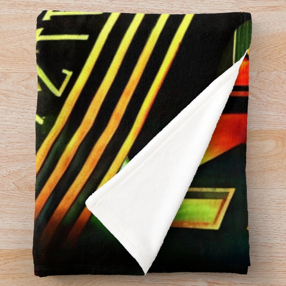 Plush blanket featuring a Metropolis-inspired futuristic cinema design with green, red, black, and yellow lights