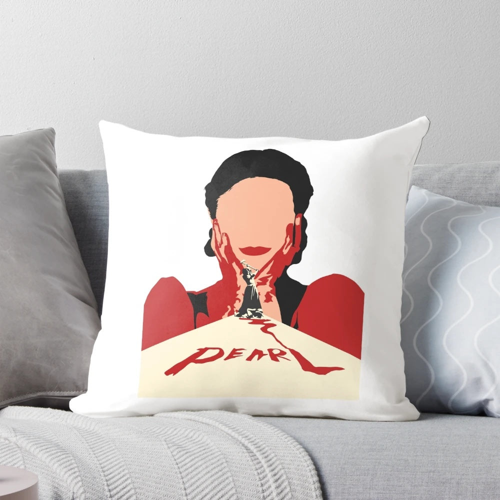 A decorative pillow featuring a close-up image of Mia Goth's character "Pearl" from the horror movie, with a bloody smile.