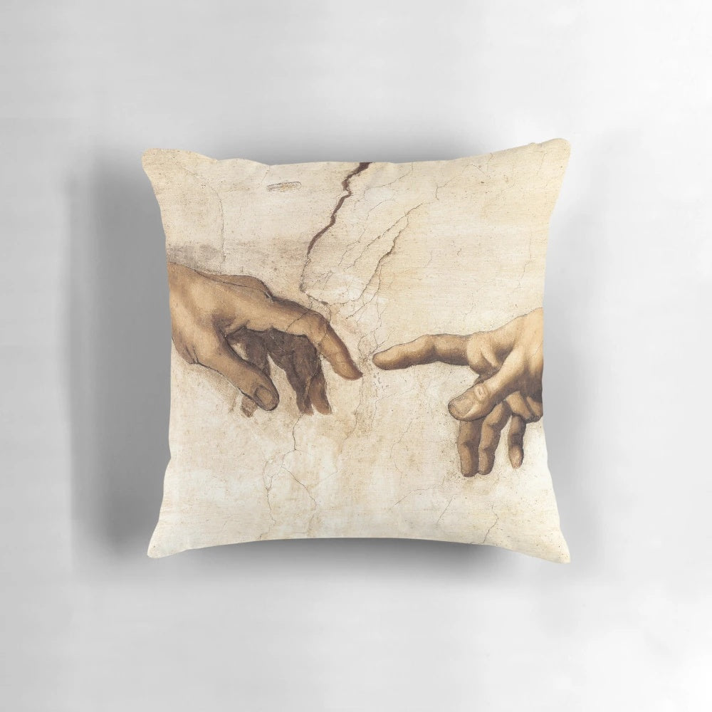 Michelangelo's iconic "Creation of Adam" painting depicted on a soft, decorative pillow for home and office decor.