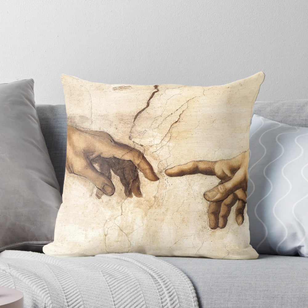 Michelangelo's iconic "Creation of Adam" painting depicted on a soft, decorative pillow for home and office decor.
