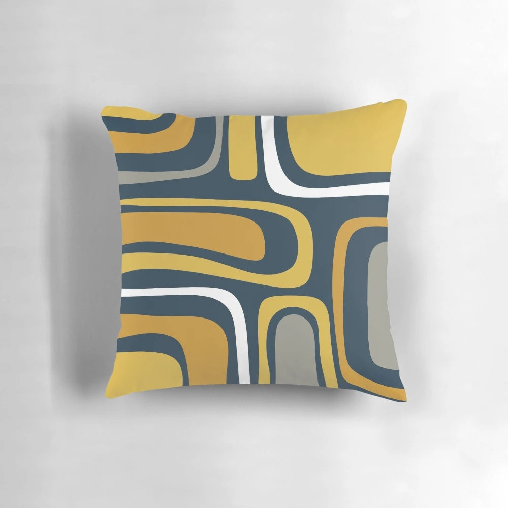 Mid-century modern abstract pattern in light and dark mustard, gray, and white on navy blue pillow