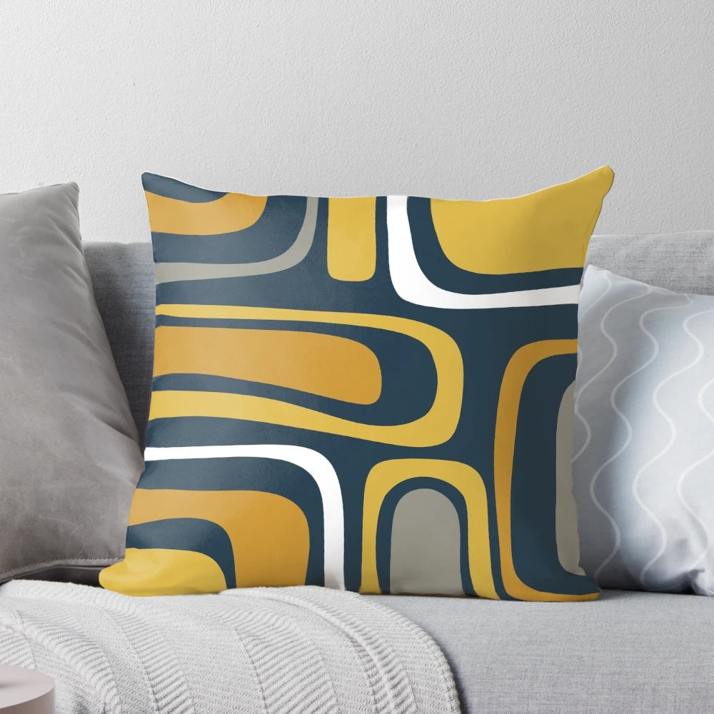 Mid-century modern abstract pattern in light and dark mustard, gray, and white on navy blue pillow