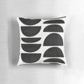 Mid-century modern black and white concrete pillow with a unique circle pattern.