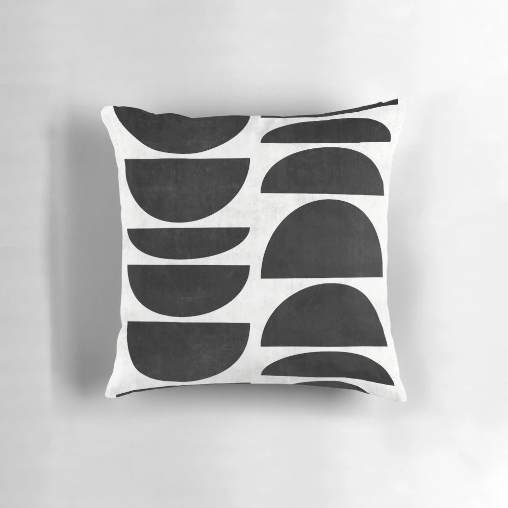 Mid-century modern black and white concrete pillow with a unique circle pattern.