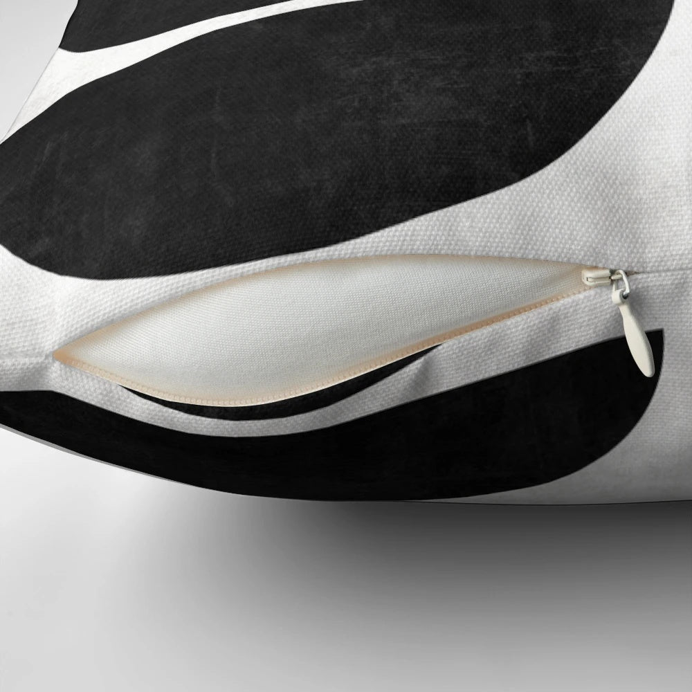 Mid-century modern black and white concrete pillow with a unique circle pattern.