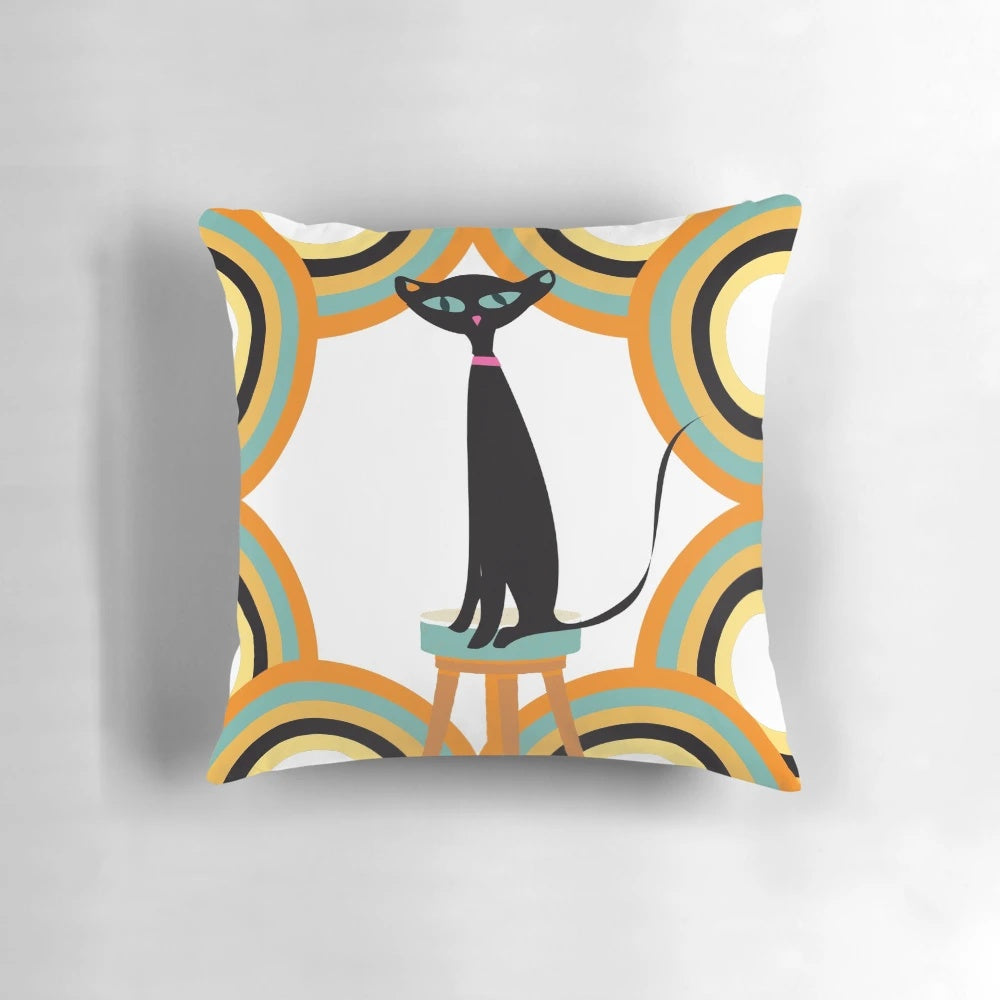 A black cat sitting among a variety of retro-styled shapes and patterns on a mid-century modern-inspired throw pillow.
