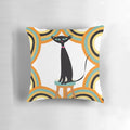 A black cat sitting among a variety of retro-styled shapes and patterns on a mid-century modern-inspired throw pillow.