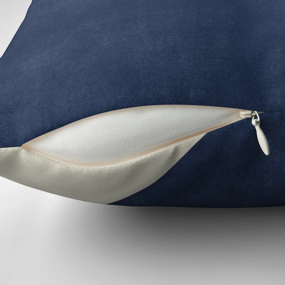 A blue and navy half circle colorblock pillow in a mid-century modern style.