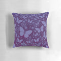 Decorative midnight blue and purple pillow with a field of butterflies against a starry night sky