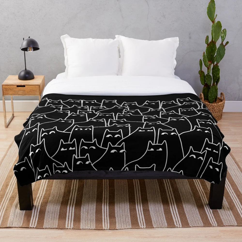 Plush blanket featuring a minimal black and white cat pattern design