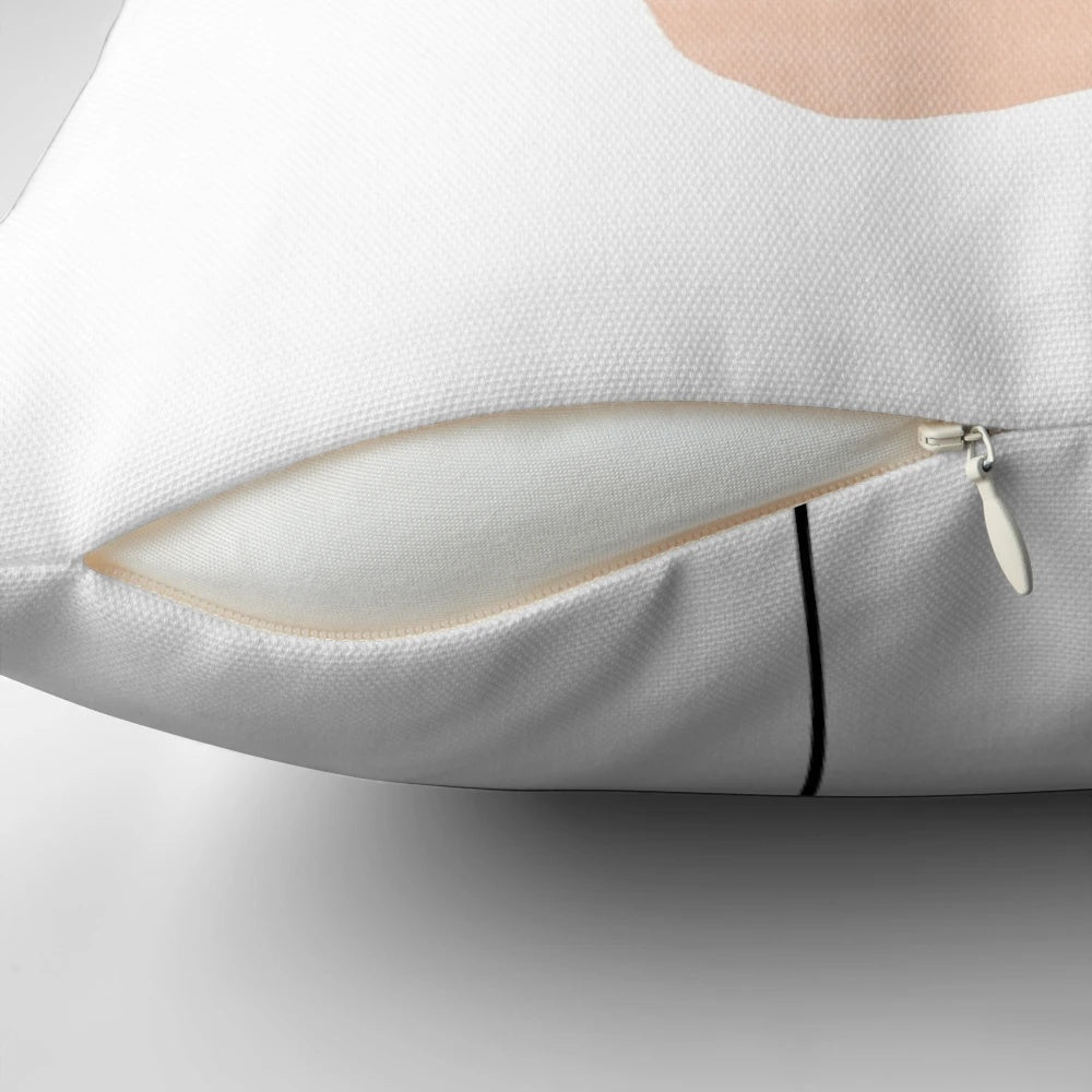 Minimalist abstract face design printed on a decorative throw pillow