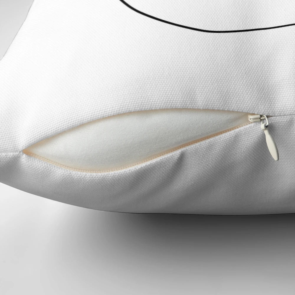 Minimalist abstract face design in one continuous line on a throw pillow
