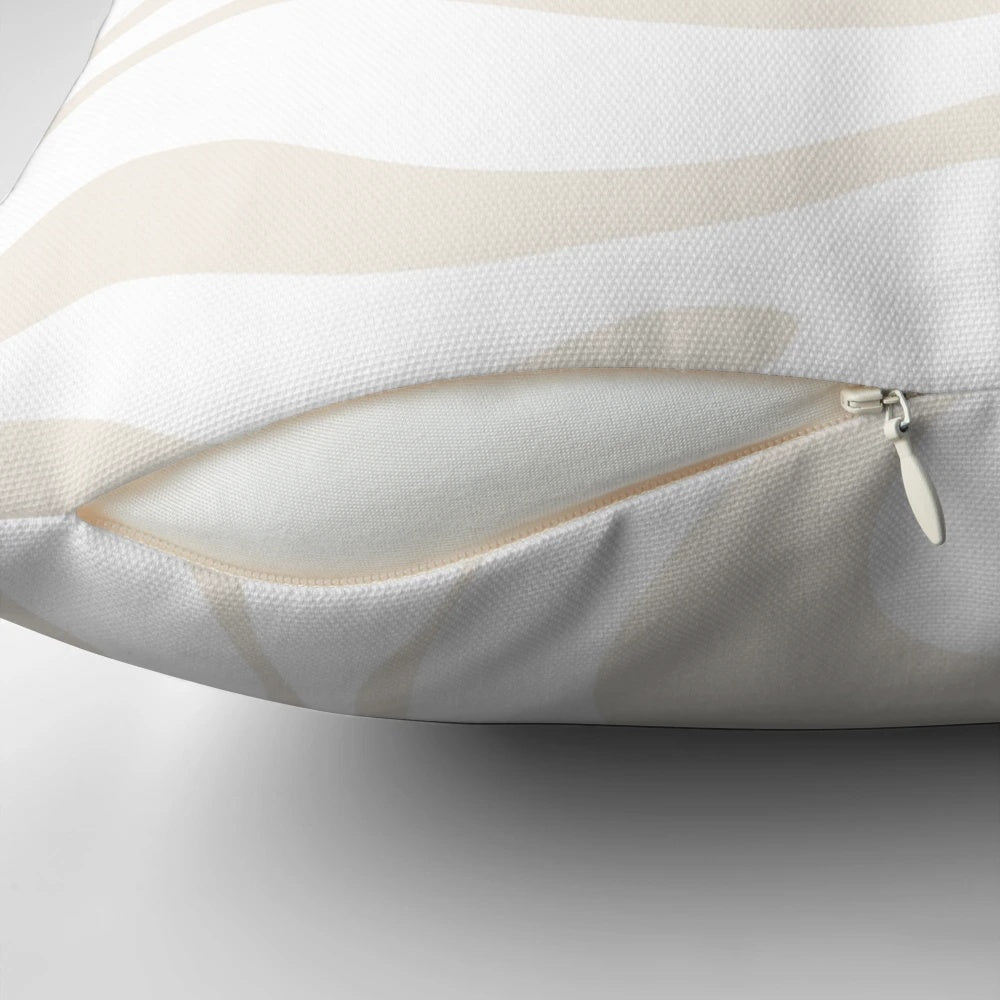 Soft, modern abstract pattern pillow in neutral white and beige tones