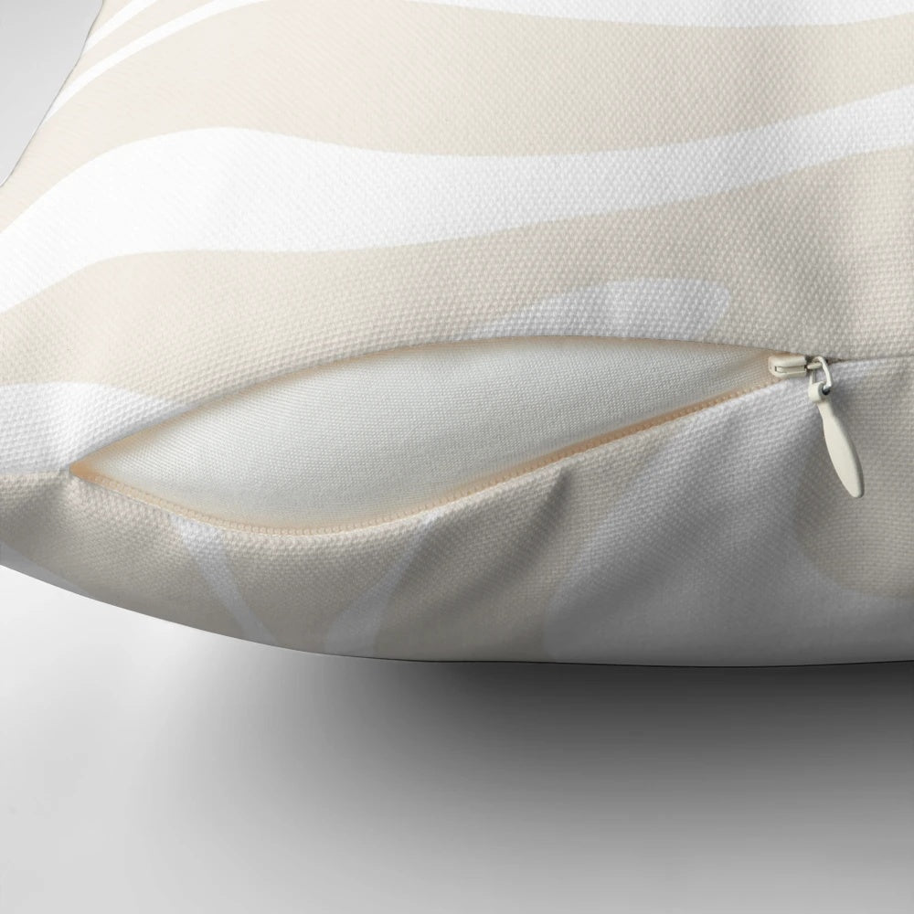 A modern abstract swirl pattern in light beige and white colors on a minimalist decorative pillow.