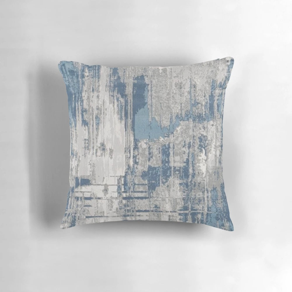 Minimalist abstract throw pillow in shades of teal, gray, and neutral colors with a textured, modern design.