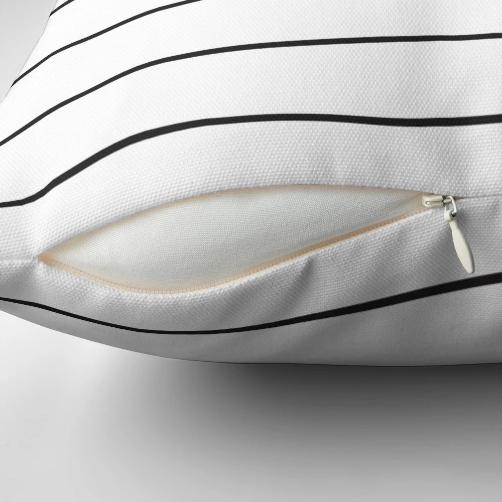Minimalist black and white striped pillow with a geometric, vector pattern design