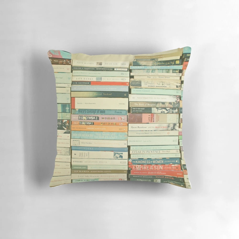 Decorative pillow featuring an abstract stack of book spines in a minimalist, modern design