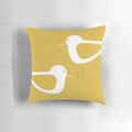 Minimalist coastal pillow featuring a pair of shorebirds in light mustard yellow and white