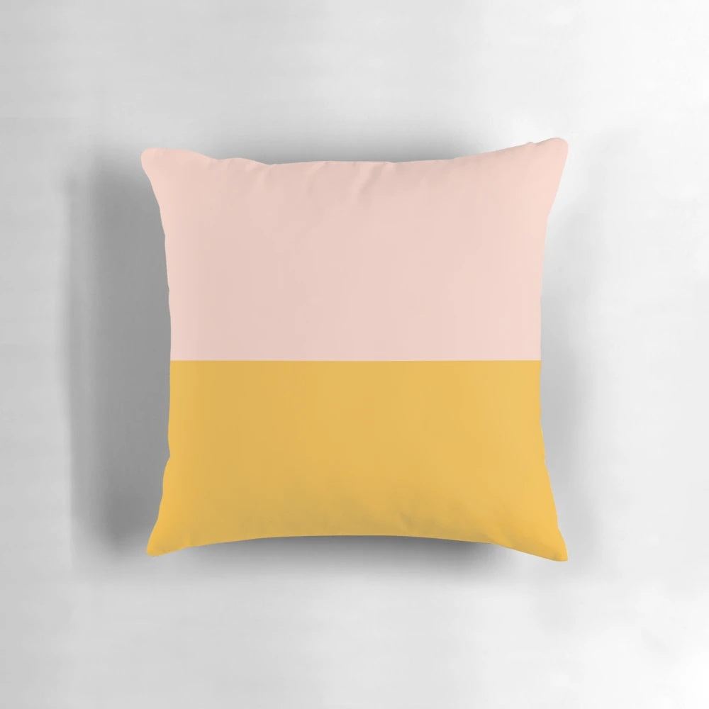 Minimalist color block pillow in soft blush pink and mustard yellow hues