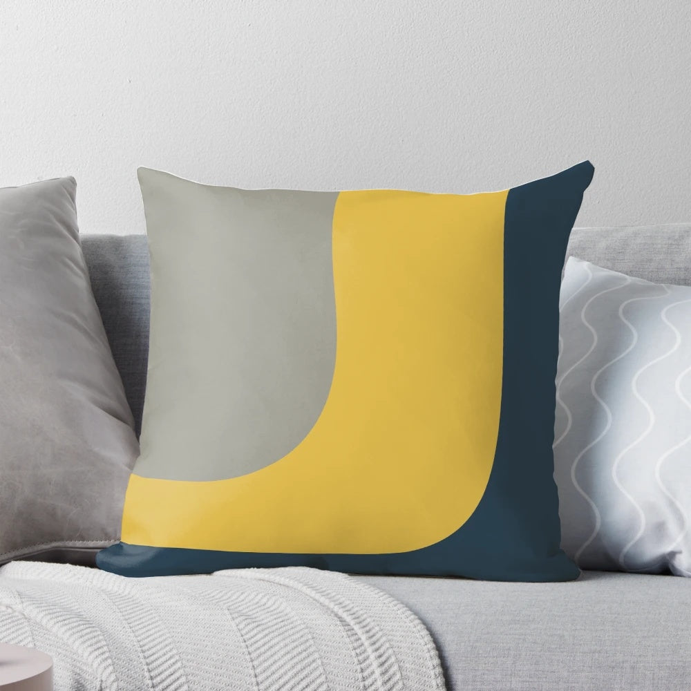 Minimalist color block pillow in a vibrant mustard, navy, and grey pattern.