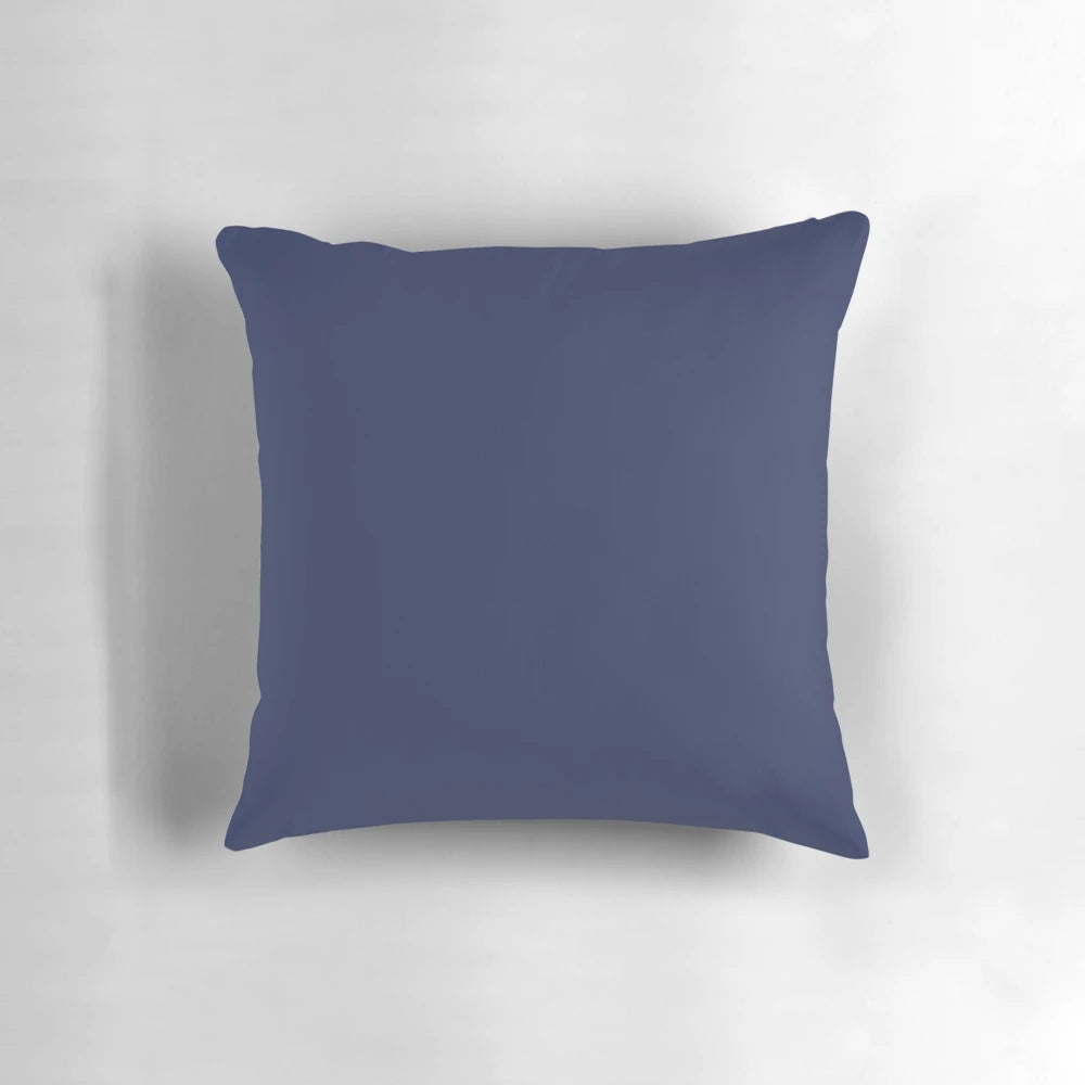 A simple, dark blue pillow with a plain, solid color design for a minimal, modern bedroom decor.