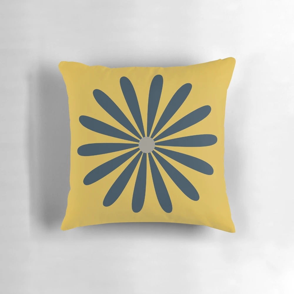 A minimalist, mid century modern geometric floral pillow in navy blue and yellow tones.