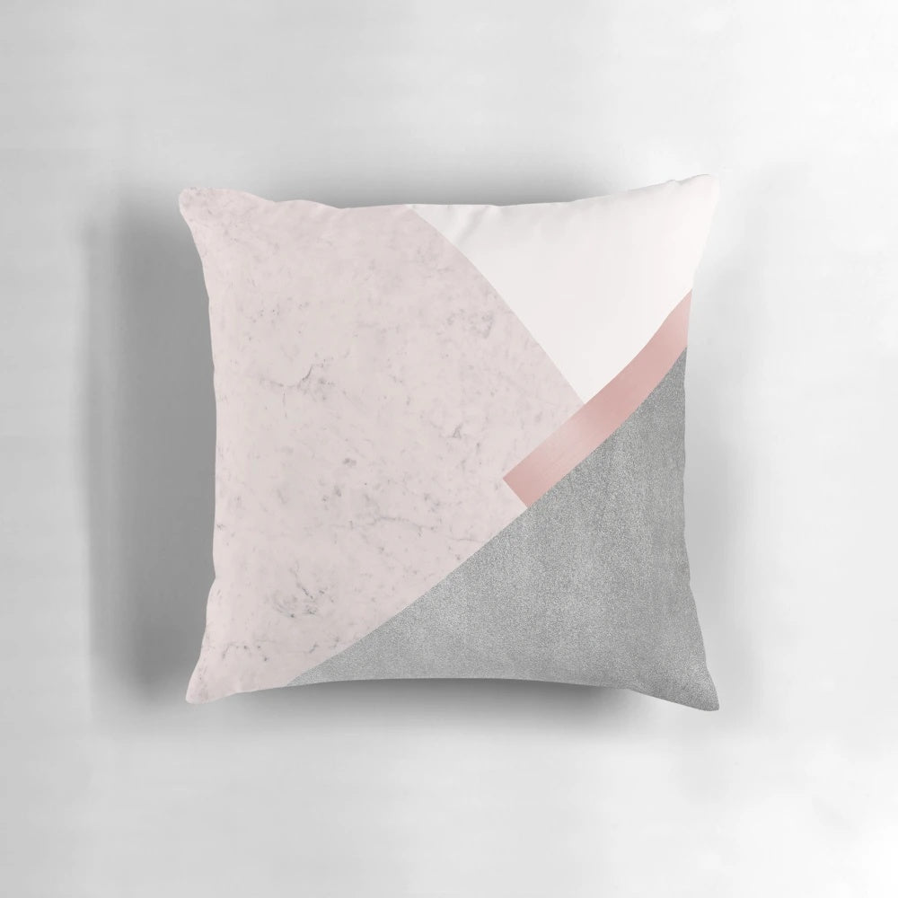 A minimalist, geometric-patterned throw pillow in a soft, pastel pink shade, perfect for a Scandinavian-inspired home decor.