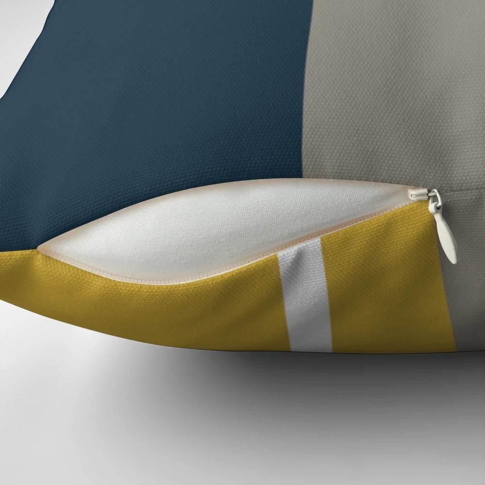 Minimalist geometric pattern pillow with a neutral color palette of mustard, navy, and gray.