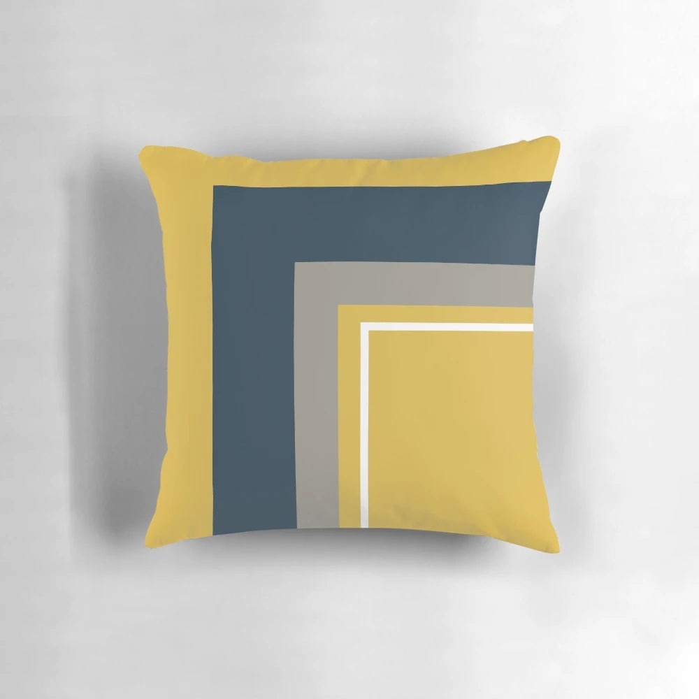 Minimalist geometric pattern pillow in mustard yellow, navy blue, grey, and white colors
