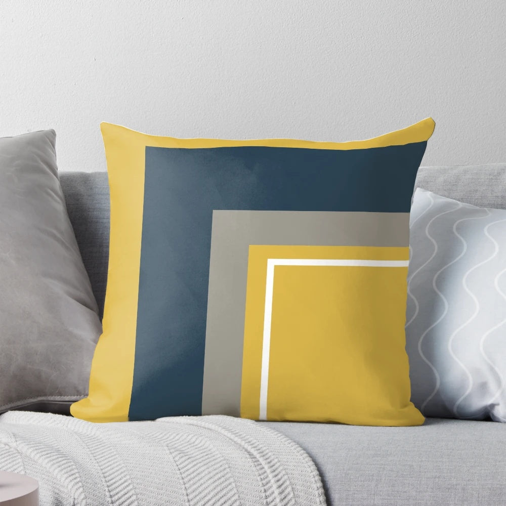 Minimalist geometric pattern pillow in mustard yellow, navy blue, grey, and white colors
