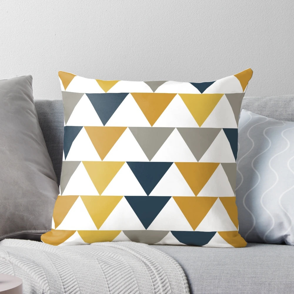 Minimalist geometric pattern pillow in mustard yellow, navy blue, and gray