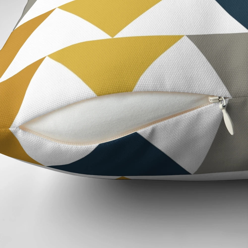Minimalist geometric pattern pillow in mustard yellow, navy blue, and gray