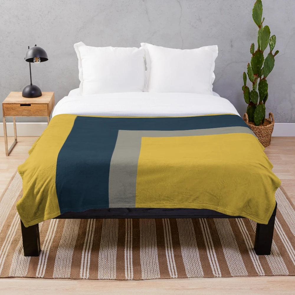 Minimalist geometric pattern plush blanket in mustard yellow, navy blue and grey