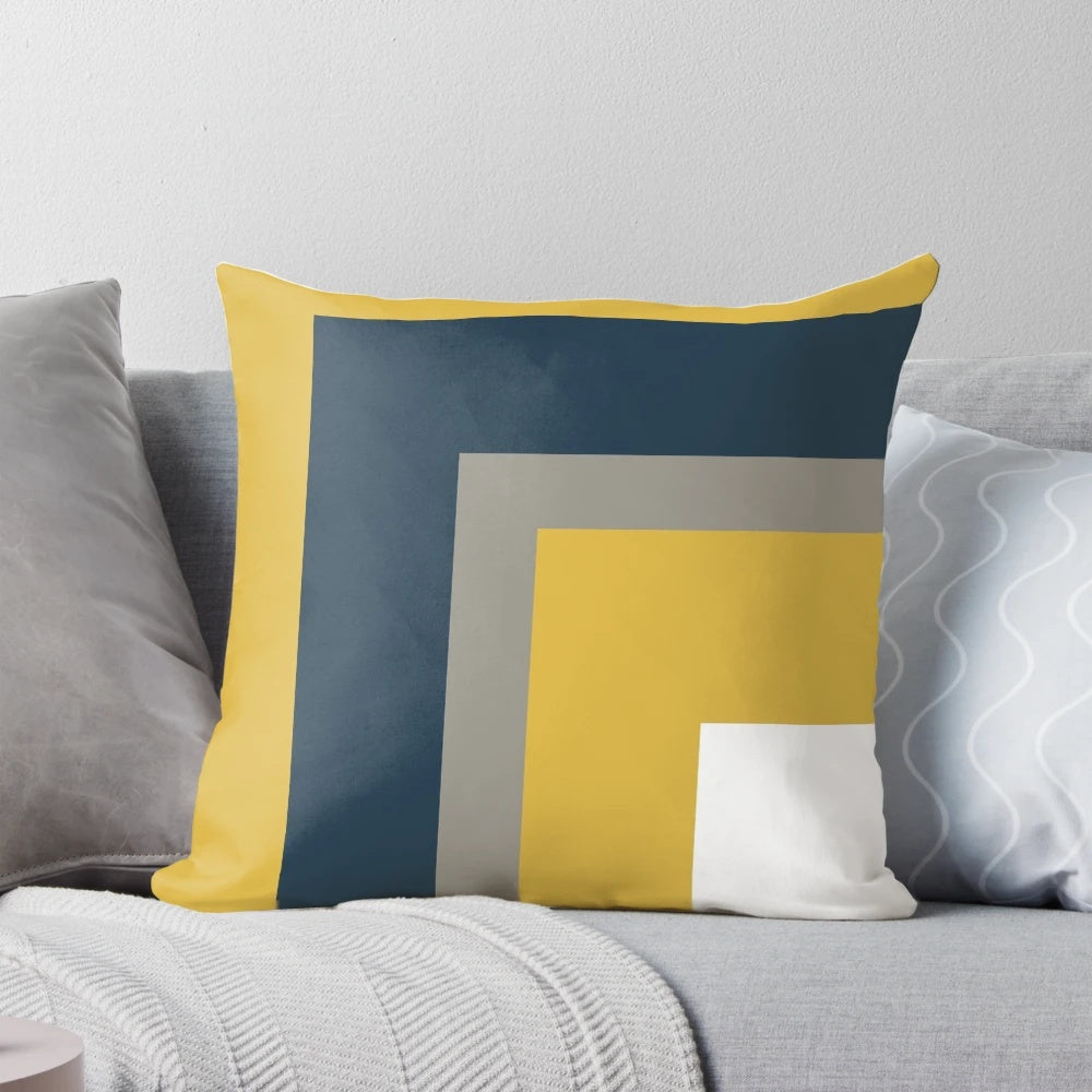 Minimalist geometric pattern pillow in mustard yellow, navy blue, and grey colors