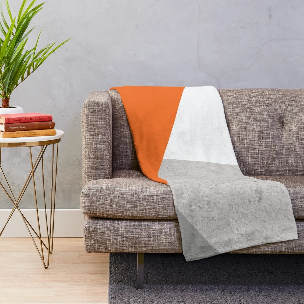 Grey orange and concrete color block plush blanket with geometric pattern