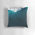 Aerial view of a lone humpback whale swimming in front of an iceberg in the Arctic waters of Greenland