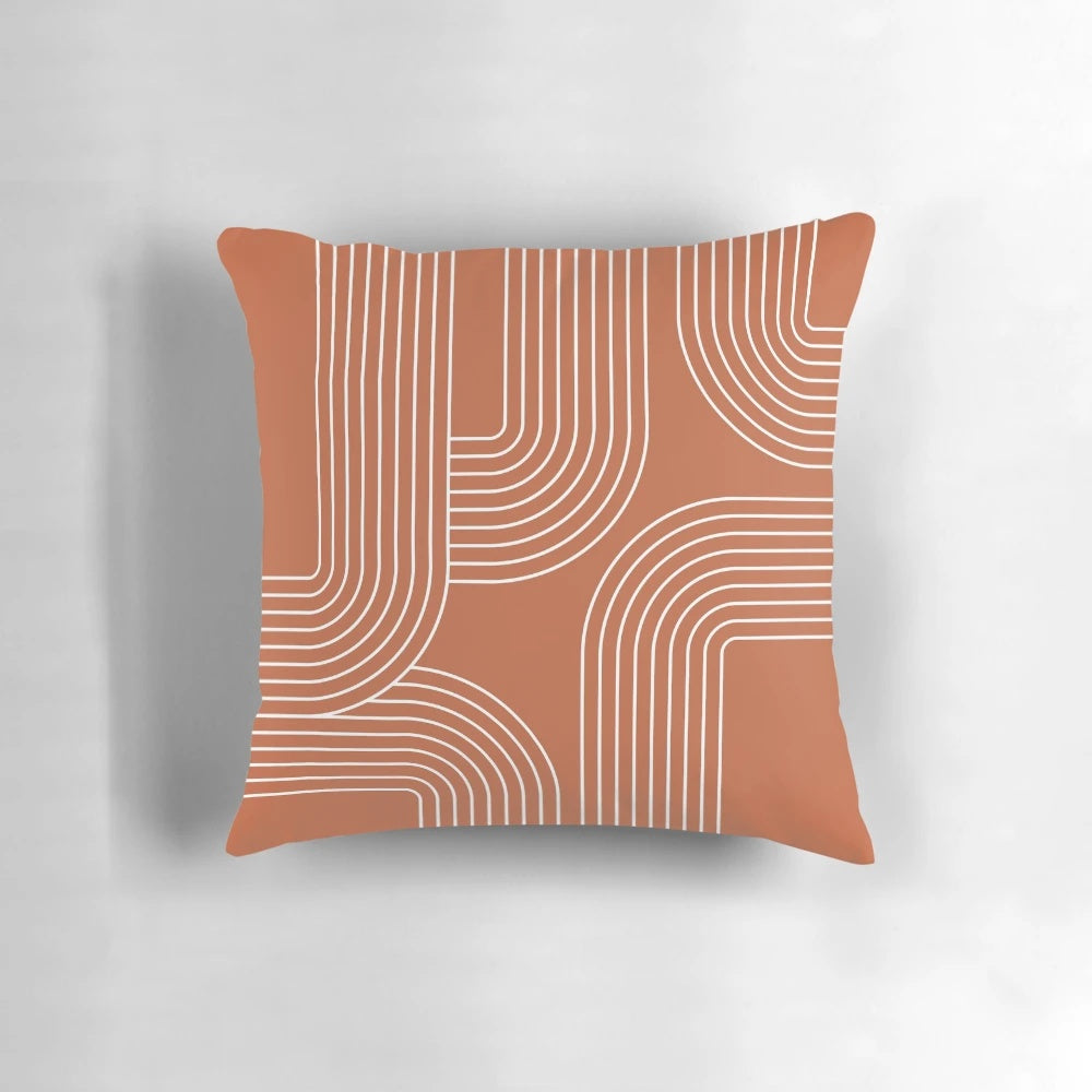 A modern, minimalist throw pillow featuring a mid-century inspired line art design in terracotta and white.