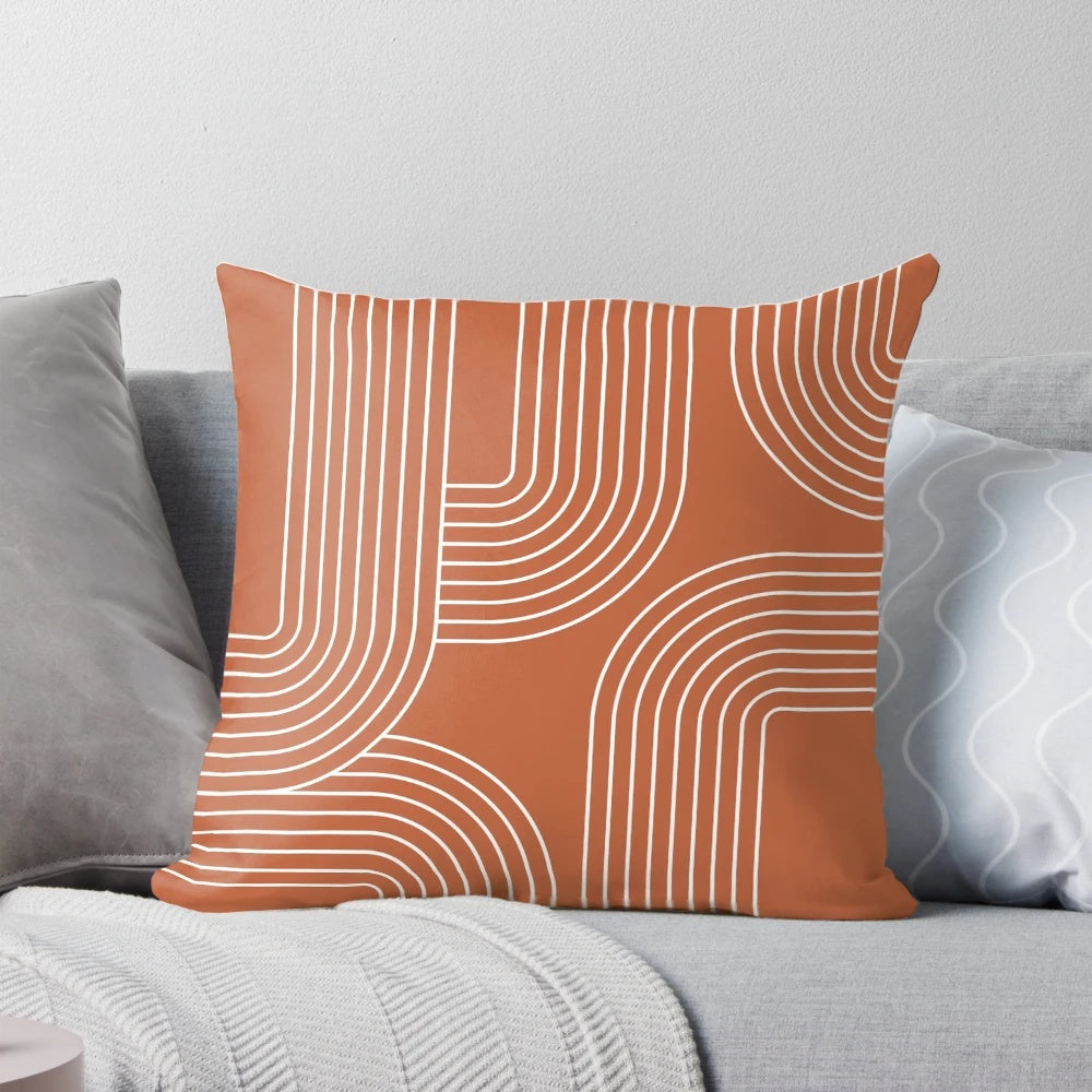 A modern, minimalist throw pillow featuring a mid-century inspired line art design in terracotta and white.