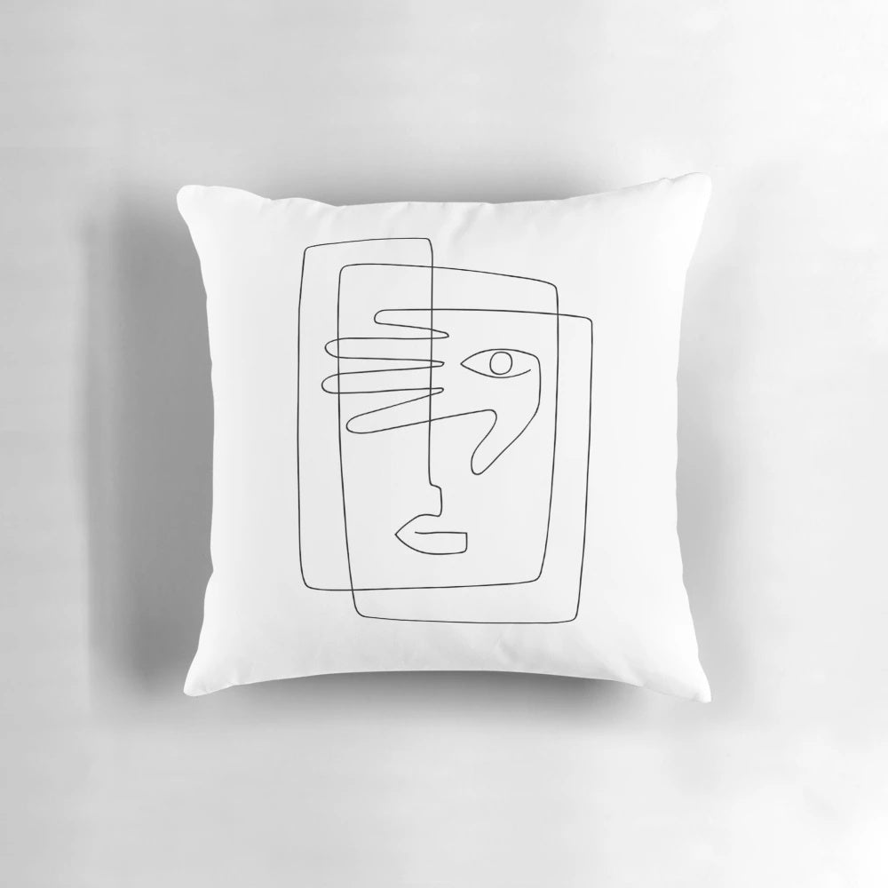 A square throw pillow featuring a simple, continuous line art design of a face.