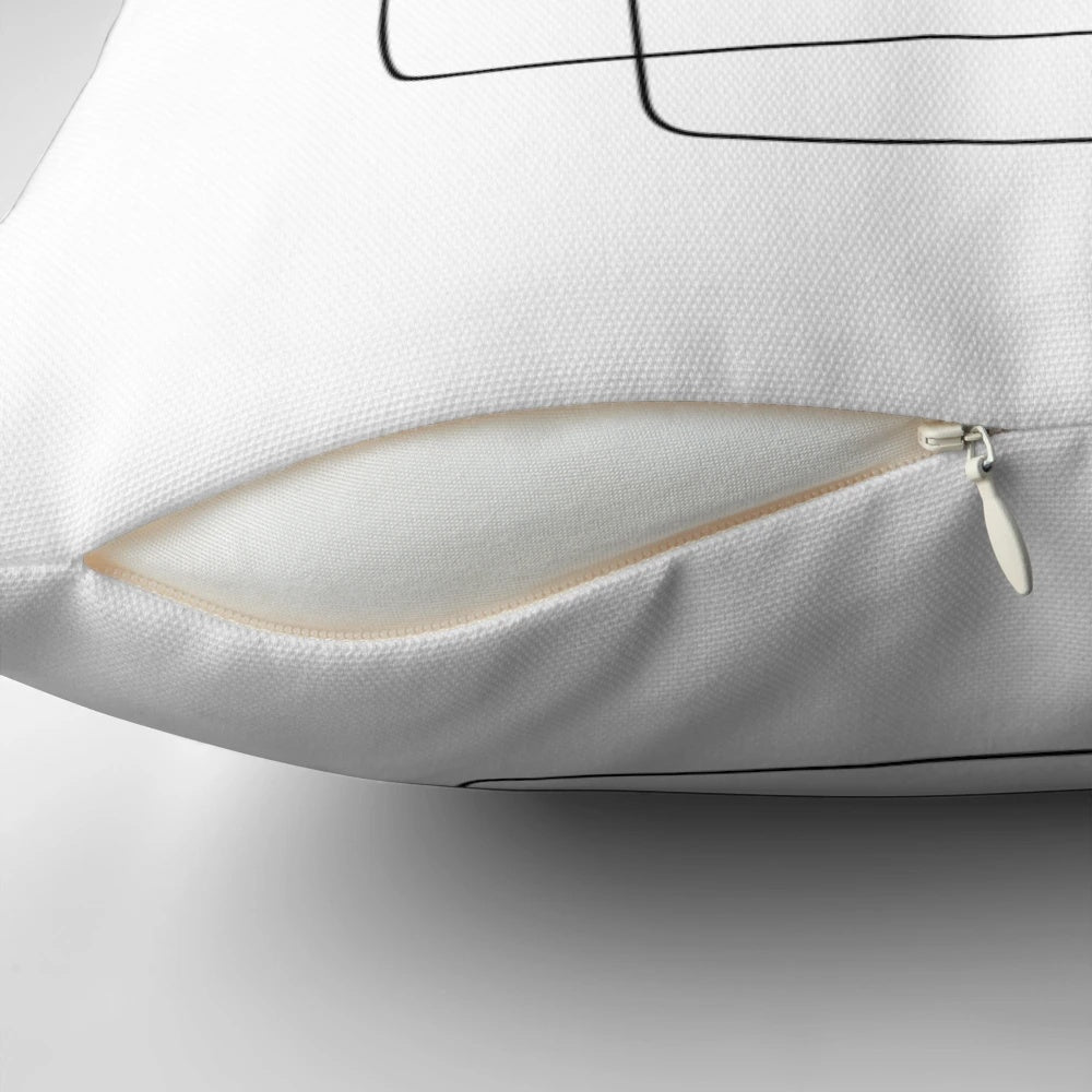 A square throw pillow featuring a simple, continuous line art design of a face.