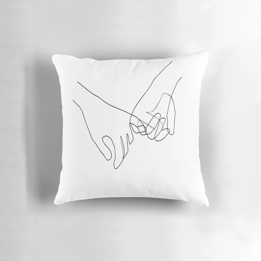 Minimalist line art design of two hands in a pinky swear gesture on a decorative pillow.