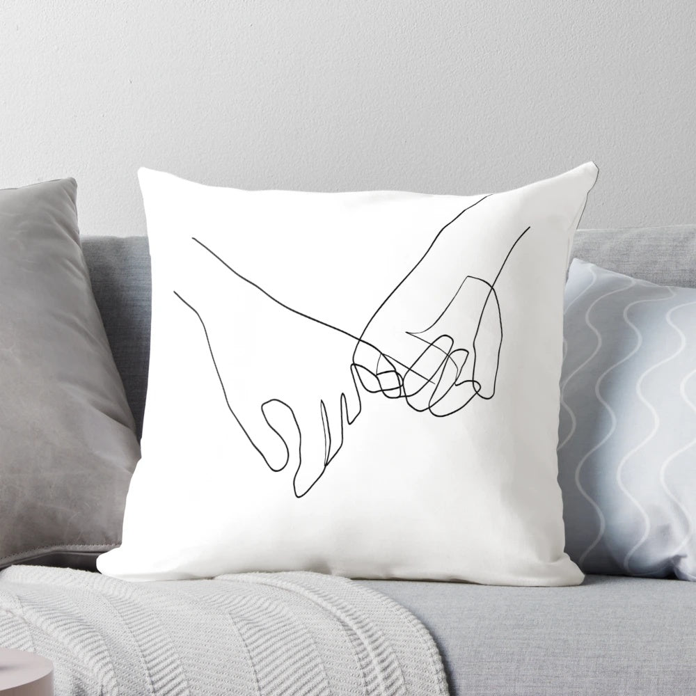 Minimalist line art design of two hands in a pinky swear gesture on a decorative pillow.