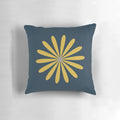 A minimalist, retro-modern navy blue throw pillow with a light mustard and grey daisy floral pattern.